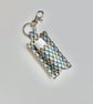 Key ring lip balm holder in grey geometric fabric