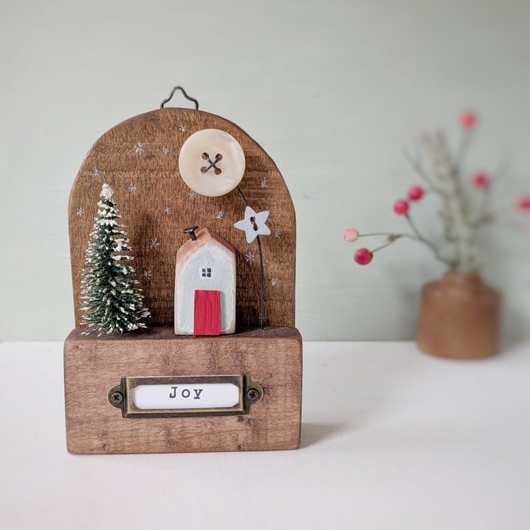 Festive Wooden Cottage Scene with Star and Moon