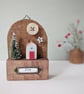 Festive Wooden Cottage Scene with Star and Moon