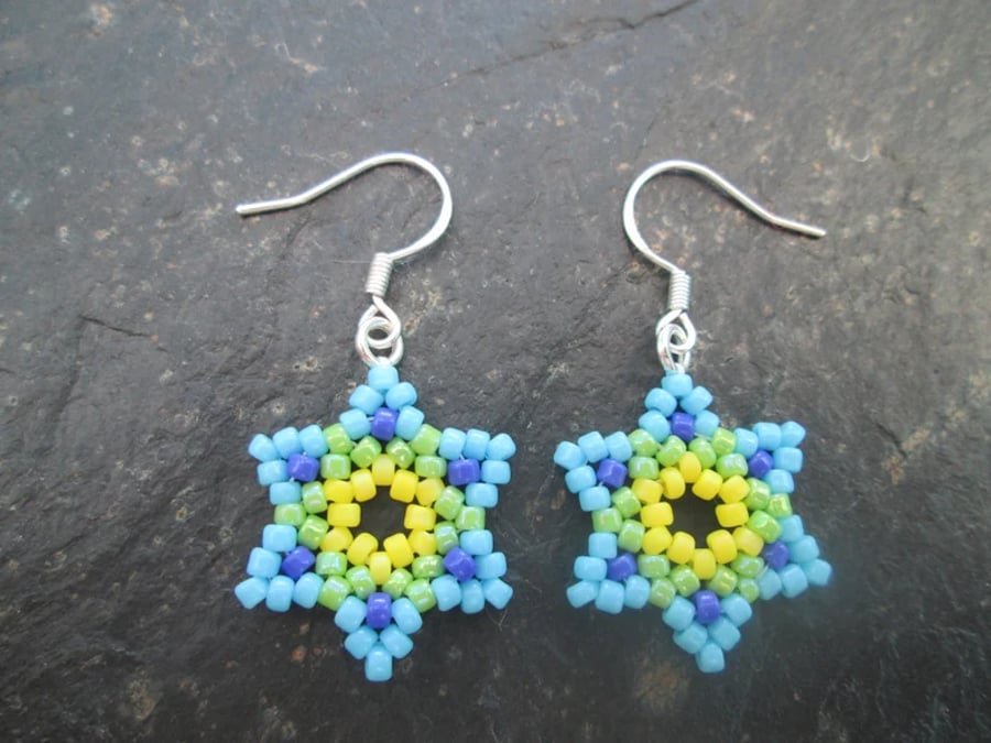 Green, blue and yellow Huichol inspired star flower beaded dangle earrings