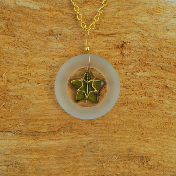 Frosty glass ring pendant with olive star