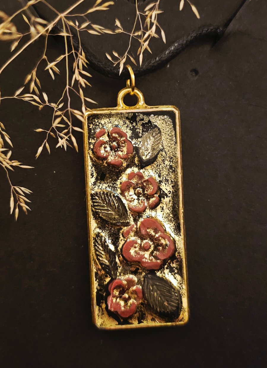 Flowers on gold pendant