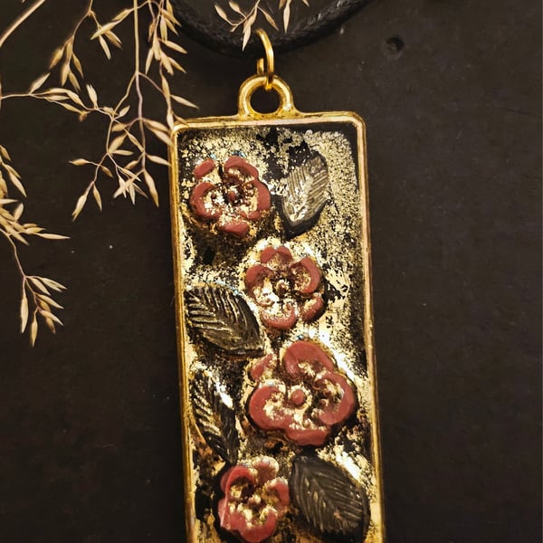 Flowers on gold pendant