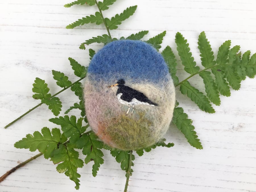 Oystercatcher embroidered brooch on needle-felted background