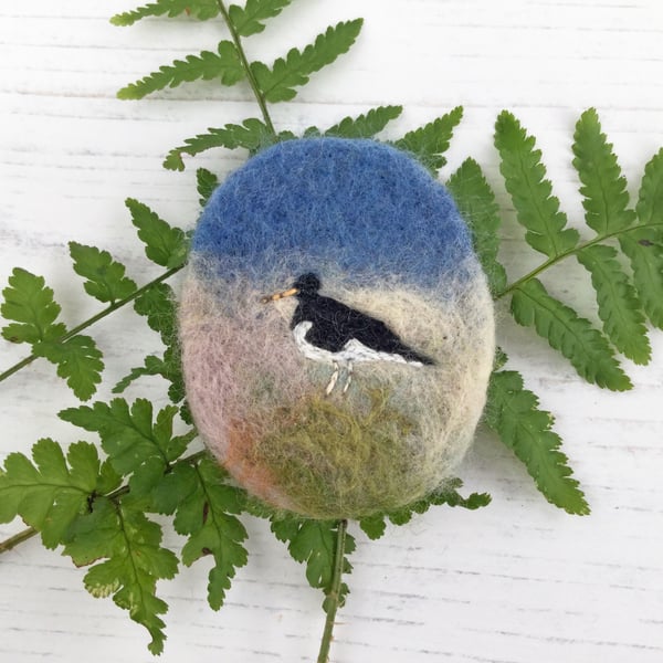 Oystercatcher embroidered brooch on needle-felted background