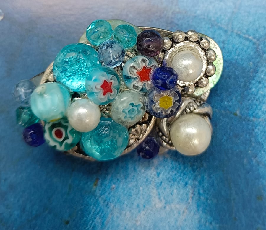 Heaps of Icey Blues and Pearls and Silver Gems on an Oval Brooch