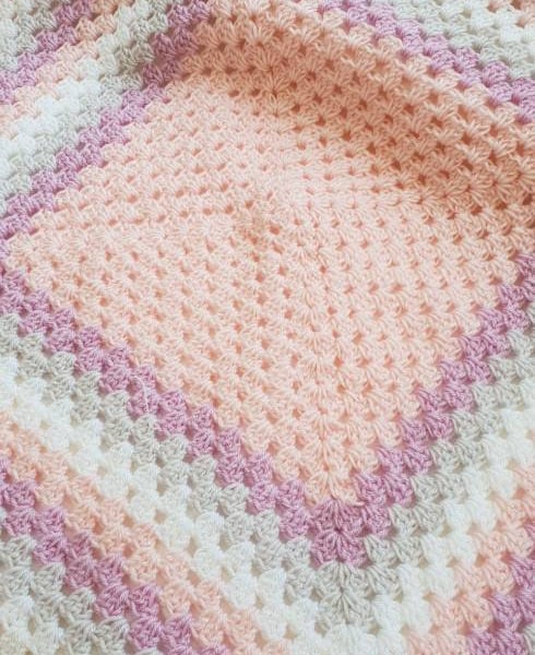 Handmade pink, purple, grey and white granny square baby blanket