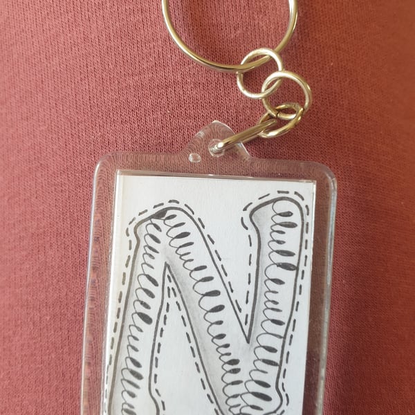 Hand drawn initial "N" keyring.