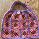 Granny square crochet handbag in orange, burgundy, raspberry and purple
