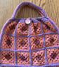Granny square crochet handbag in orange, burgundy, raspberry and purple