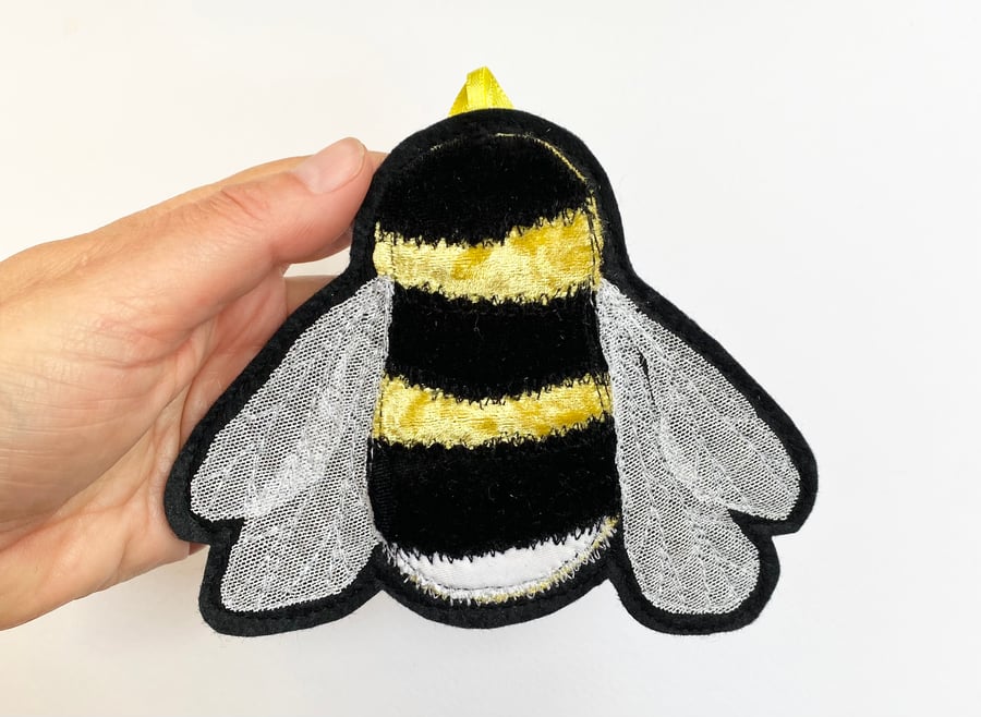 Upcycled embroidered bee home decoration. 