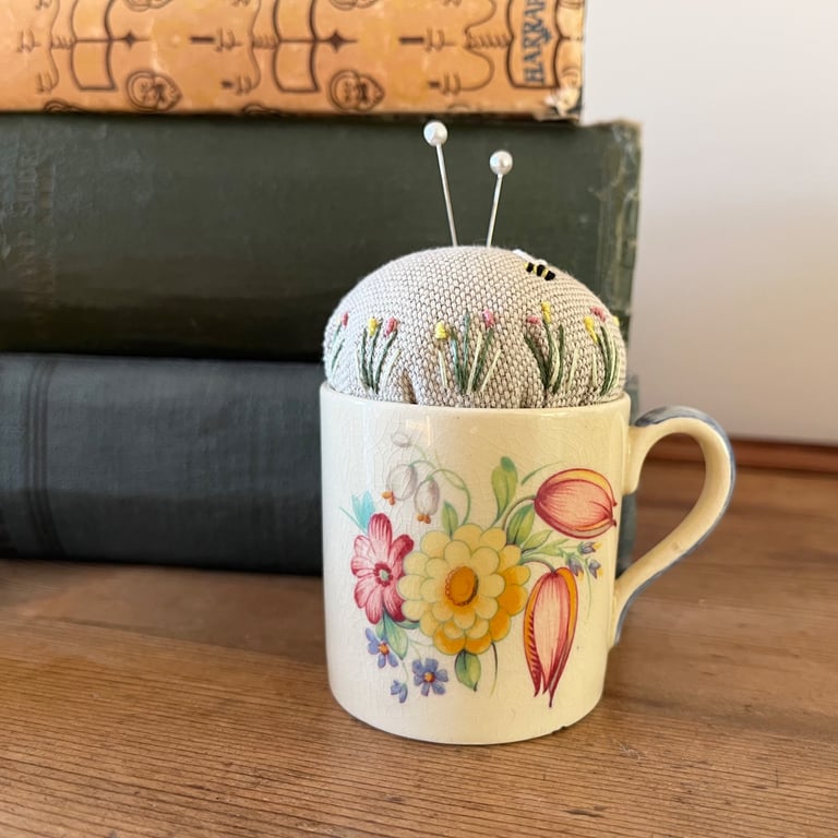 Vintage Susie Cooper coffee cup pincushion with embroidered linen