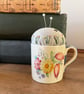 Vintage Susie Cooper coffee cup pincushion with embroidered linen