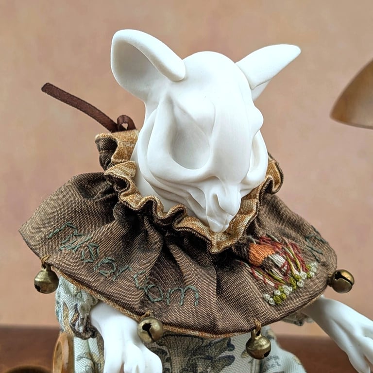 'Porcini', a white porcelain and textile mouse-skull imp.