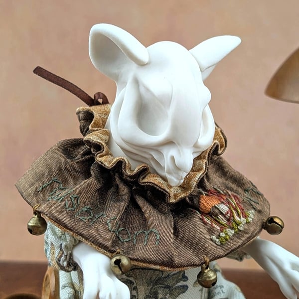 'Porcini', a white porcelain and textile mouse-skull imp.