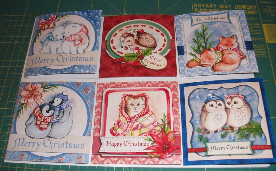 Set of 6 Christmas card with cute cosy up at Christmas animal designs.