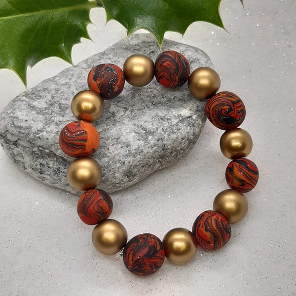 Red, orange and gold polymer clay bracelet