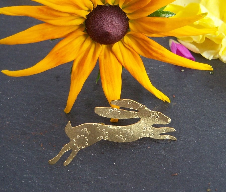 Hare brooch in brass with imprinted flower design