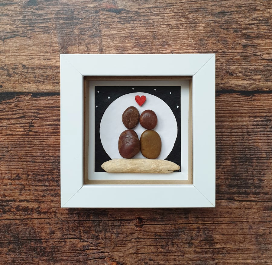 Pebble and driftwood couple in moonlight 