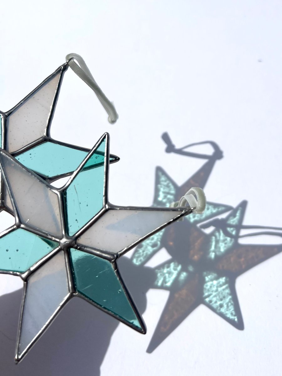 Image of Pastel hued white and pale blue green stained glass Christmas star decoration