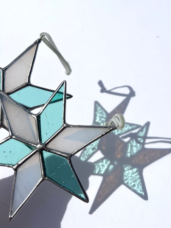Pastel hued white and pale blue green stained glass Christmas star decoration