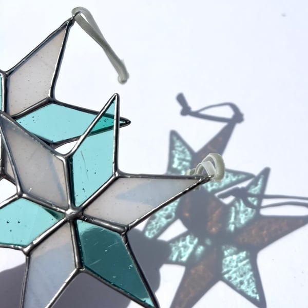 Pastel hued white and pale blue green stained glass Christmas star decoration