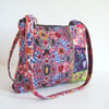 Shoulder bag or handbag made in a  Folk art print with a chunky zip .