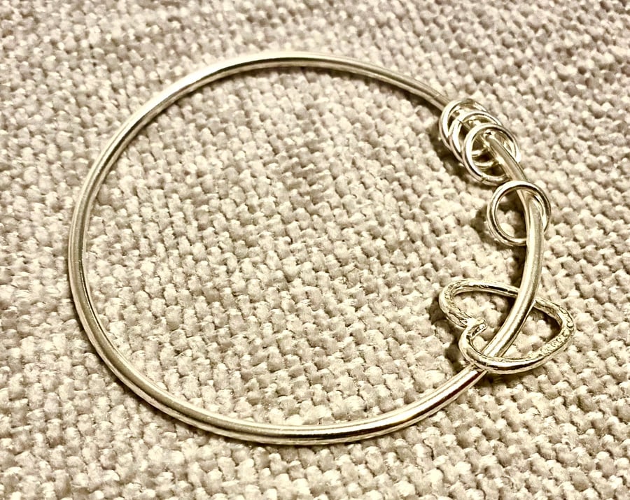 Heart charm and rings  on a heavy weight silver bangle