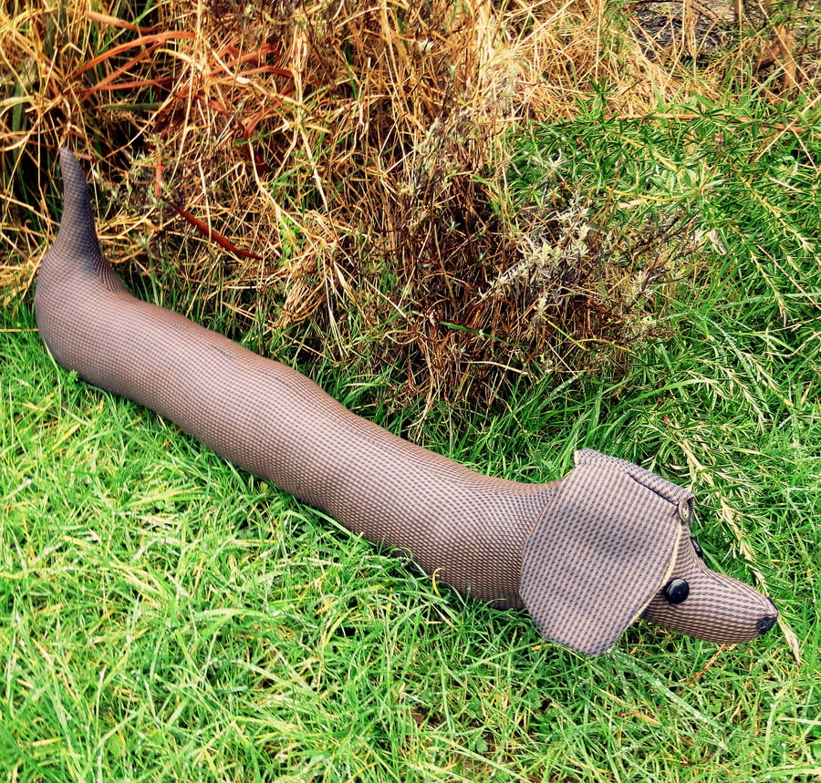 Long dog.  A smaller draught excluder to fit a recessed door or window.  81cm.