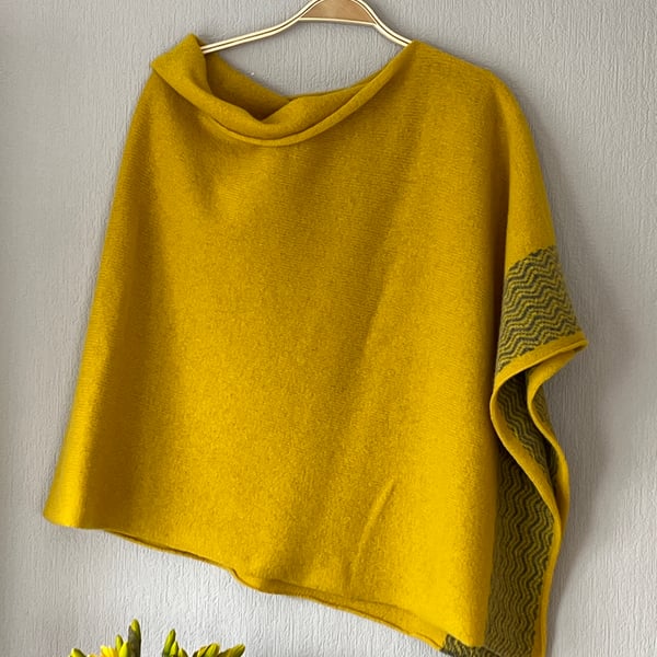 Soft merino lambswool piccalilli yellow poncho with wavy uniform grey border