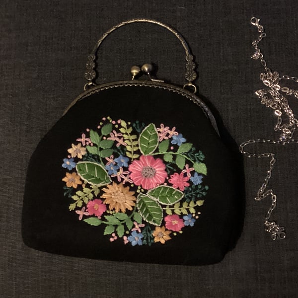 Black embroidered floral clasp bag.  