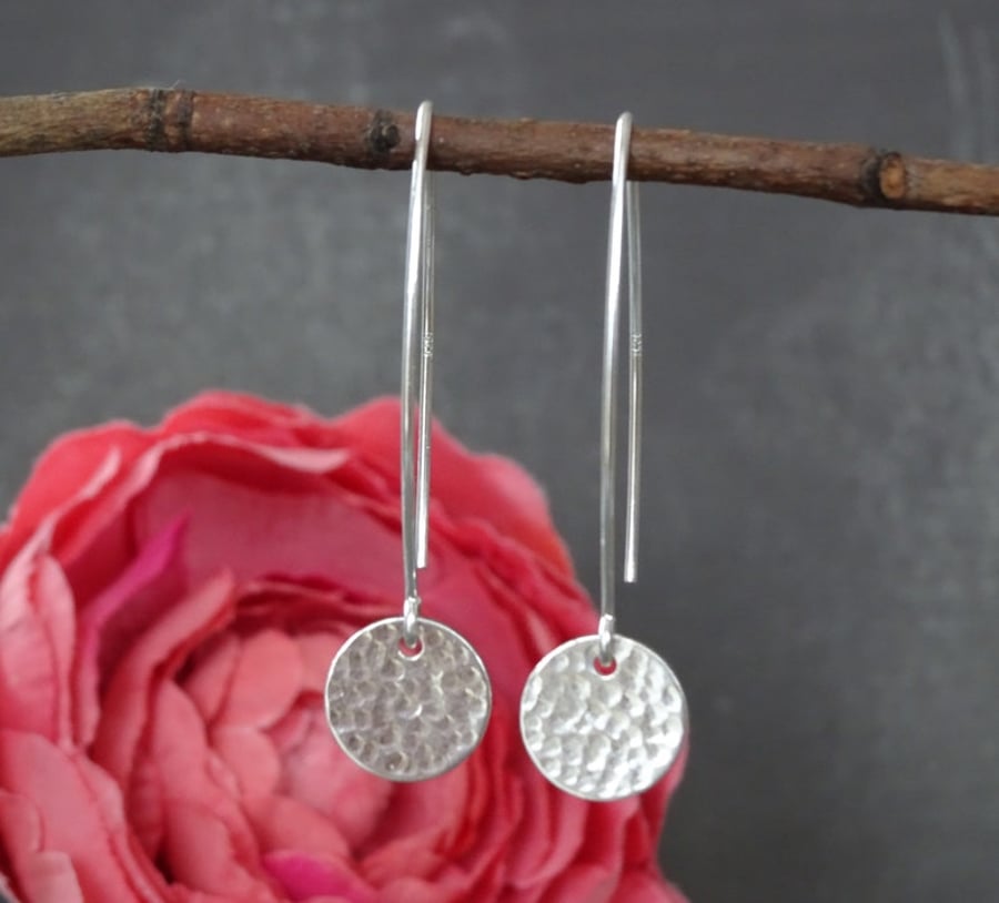 Long hammered sterling silver disc earrings.