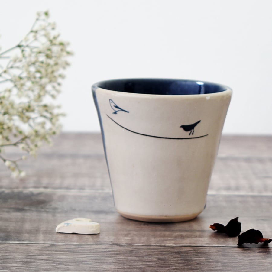 Handmade blue and white ceramic tumbler beaker cup with garden birds
