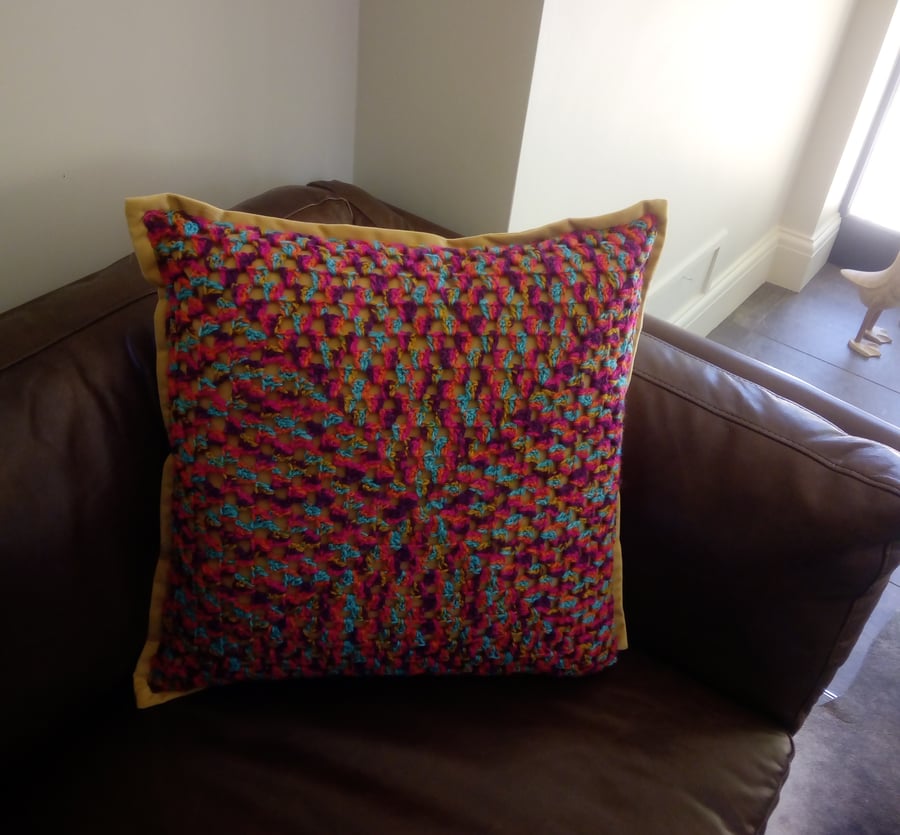 Velour cushion with hand crocheted granny square cover