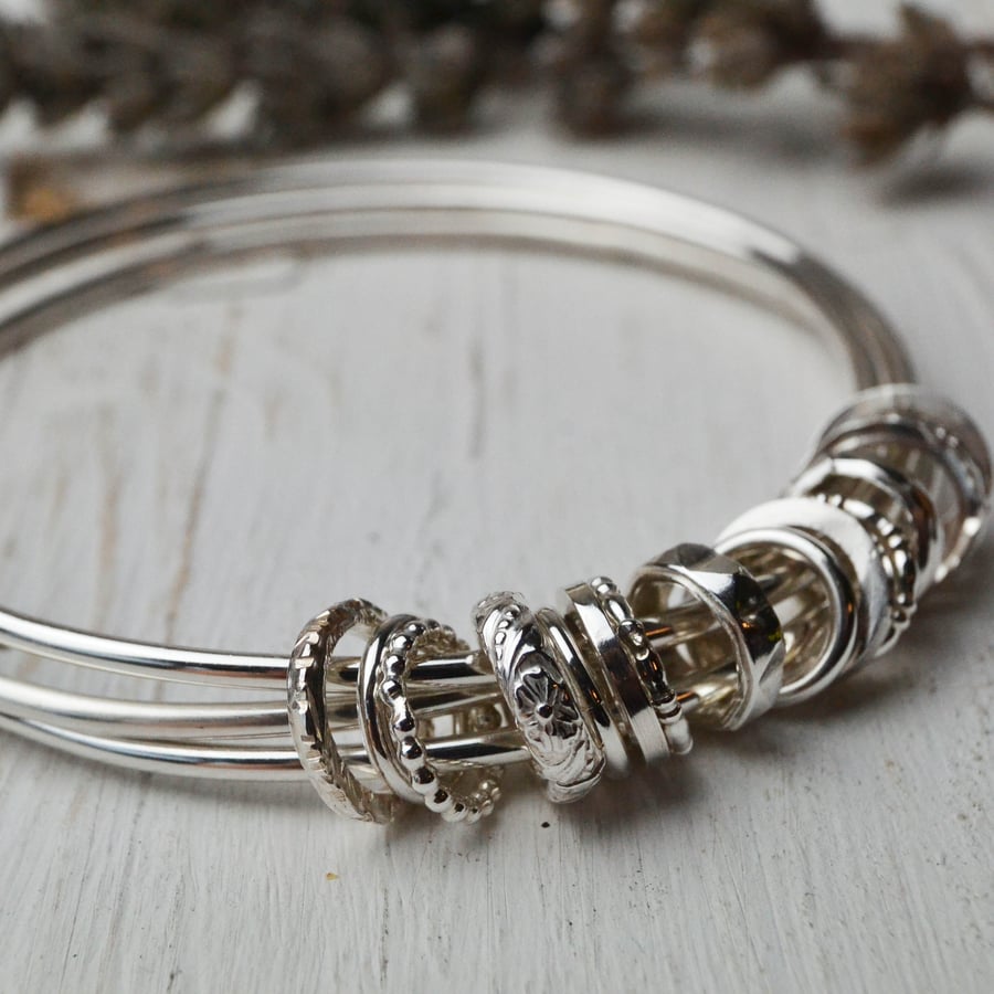 Three bangles with silver charms