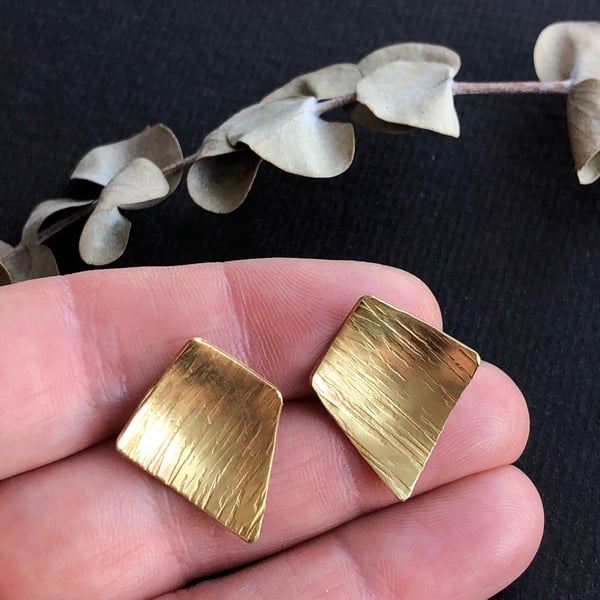 Brass and sterling silver stud earring.