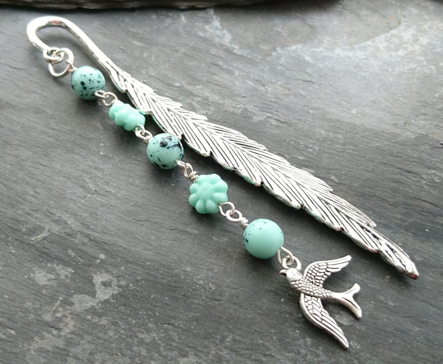 Feather bookmark with bird charm and green glass egg and flower beads