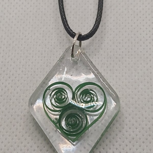 Green quilled heart necklace.