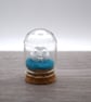 small glass glitter man in the moon figure