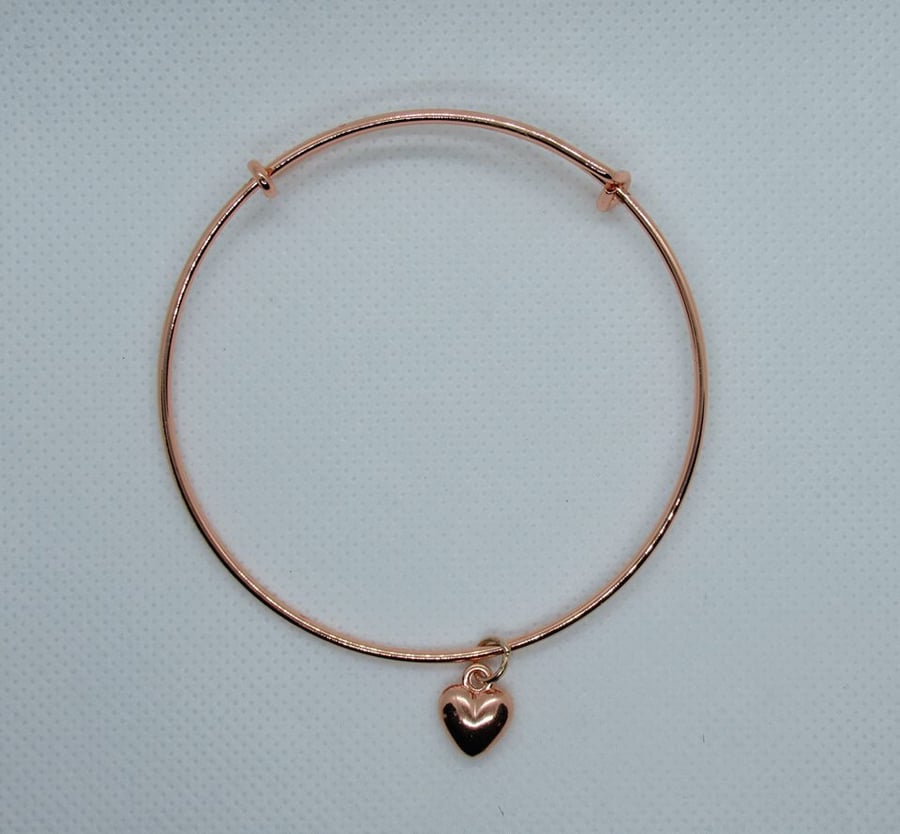 Rose gold plated expanding bangle with heart charm