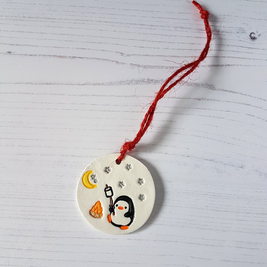 Penguin and bonfire hanging decoration, one supplied