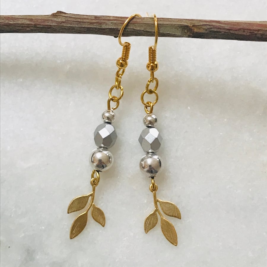 Pretty gold and silver dangle earrings with gold leaf charms 