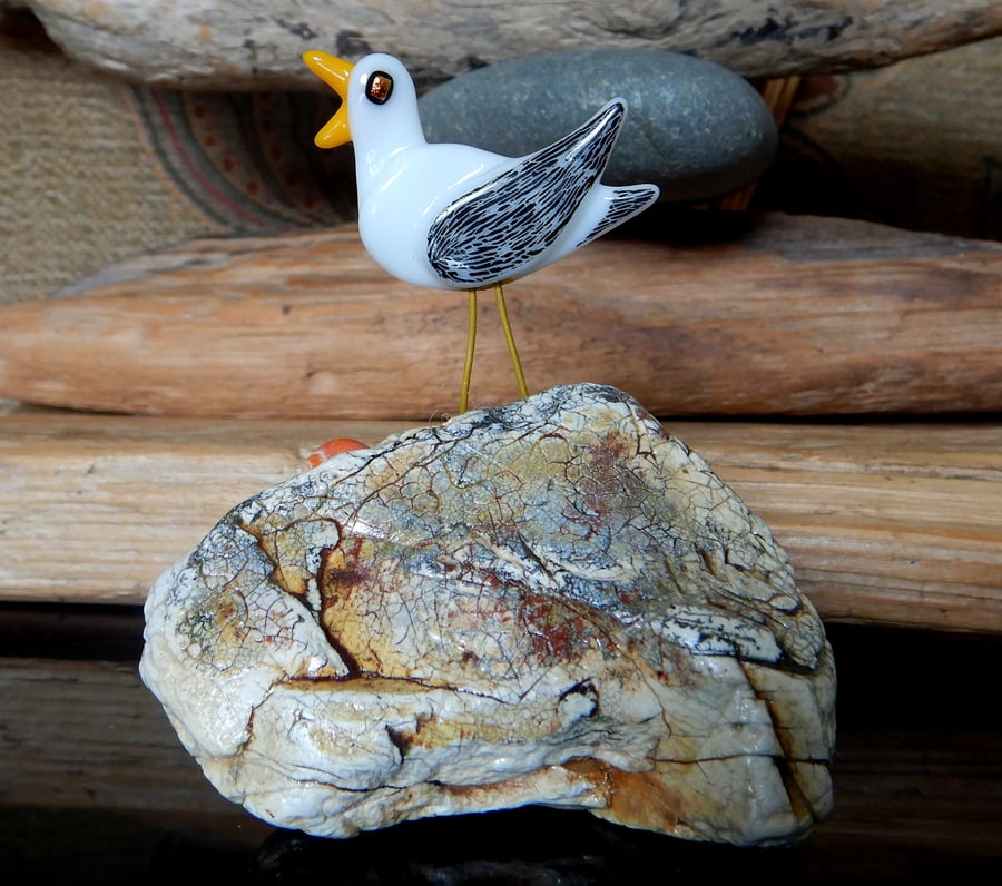 Handmade Fused Glass 'Seagull on Beach Stone' ornament.
