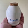 Ceramic treats bottle with flat cork.