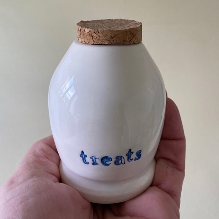 Ceramic treats bottle with flat cork.