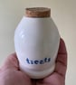 Ceramic treats bottle with flat cork.