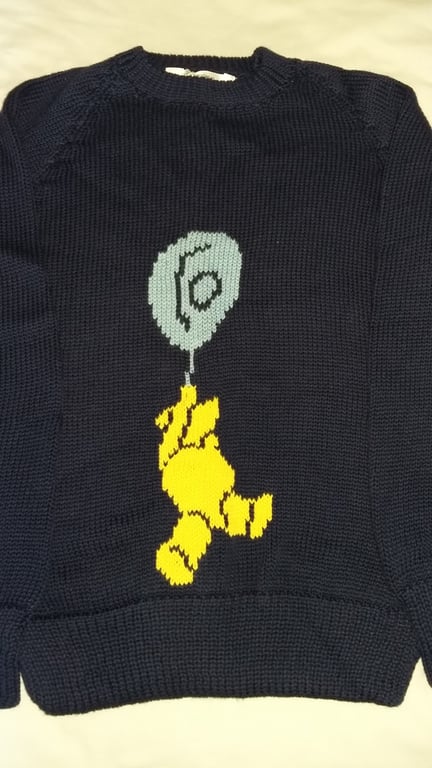 Teddy bear and balloon motif on this jumper in machine was wool or cotton