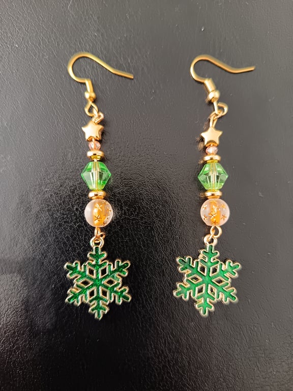 Gold and green beaded dangle earrings with stars and snowflake charms 