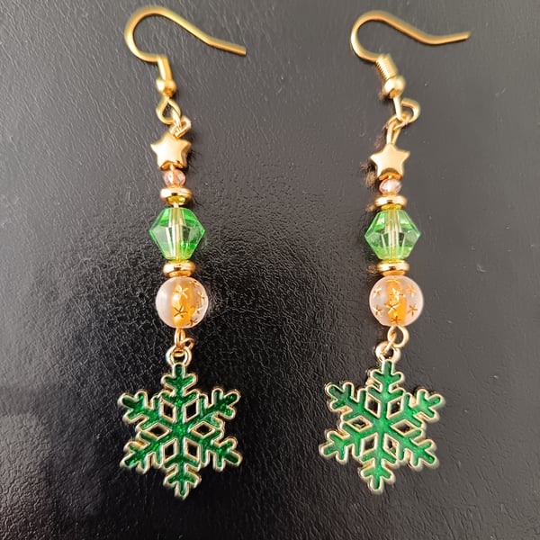 Gold and green beaded dangle earrings with stars and snowflake charms 
