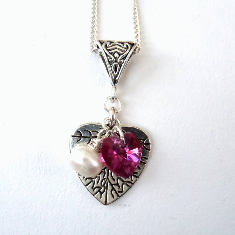 Tibetan silver charm necklace, with pearl and rose pink Swarovski crystal heart